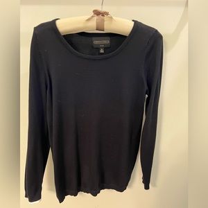 Fine knit black sweater with white sleeve detail